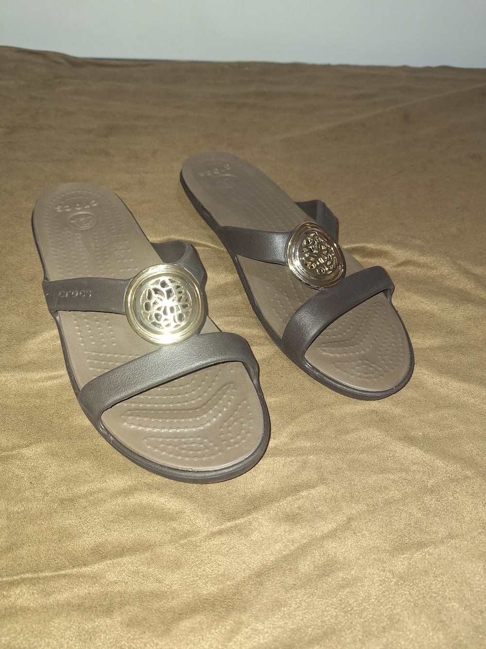 Crocs Women's Bronze Slip-On Sandals with Gold Medallion